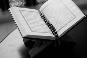 Open Qur'an with prayer beads