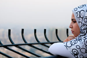 Muslim woman looking at city