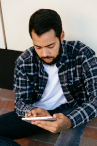 Arab Muslim reading on a device