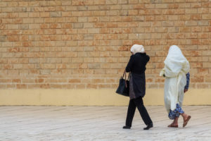 Tunisian women walking along street