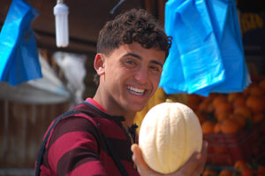 Young guy selling fruit