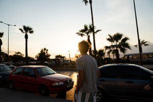 Man crossing road at sunset