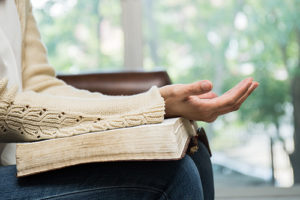 Woman praying with Bible