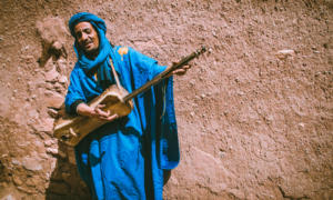 Moroccan man playing traditional instrument