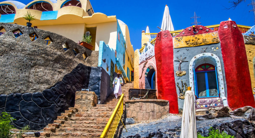 Pray for cities across the Arab world. A image of a Nubian man descends on a traditional Nubian style staircase