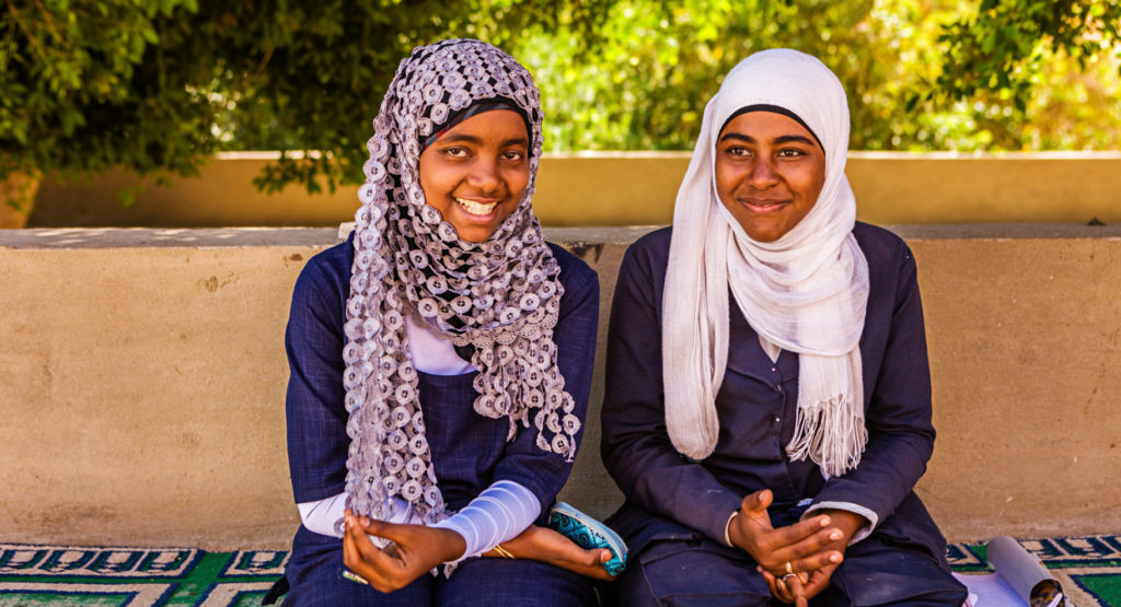Pray for cities across the Arab world. Image showing two Muslim female students in Southern Egypt